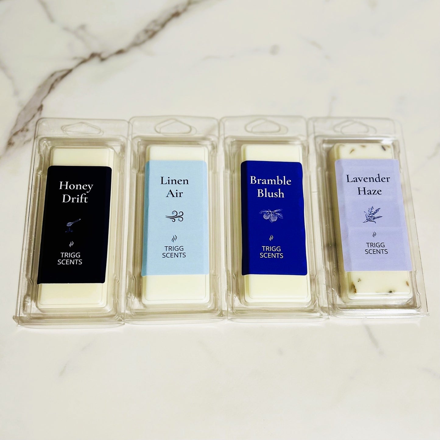 Four scented wax melt bars from the Everyday Melt Set arranged side by side