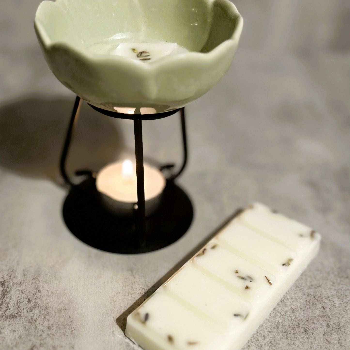 Lavender Haze wax melt melting in a ceramic burner, creating a calm and relaxing home fragrance atmosphere