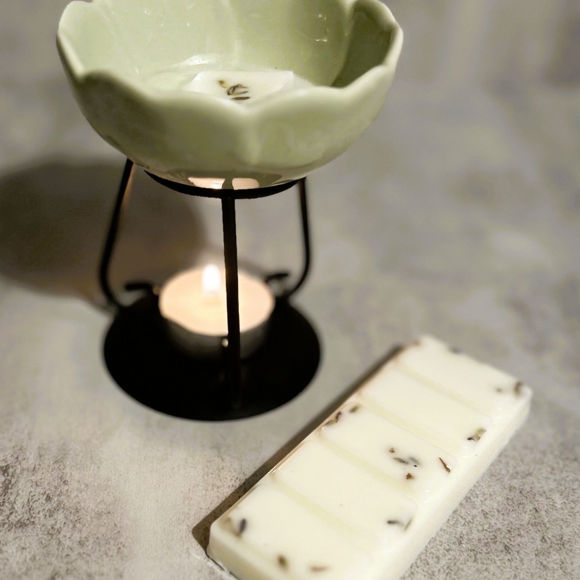 Lavender Haze wax melt melting in a ceramic burner, creating a calm and relaxing home fragrance atmosphere