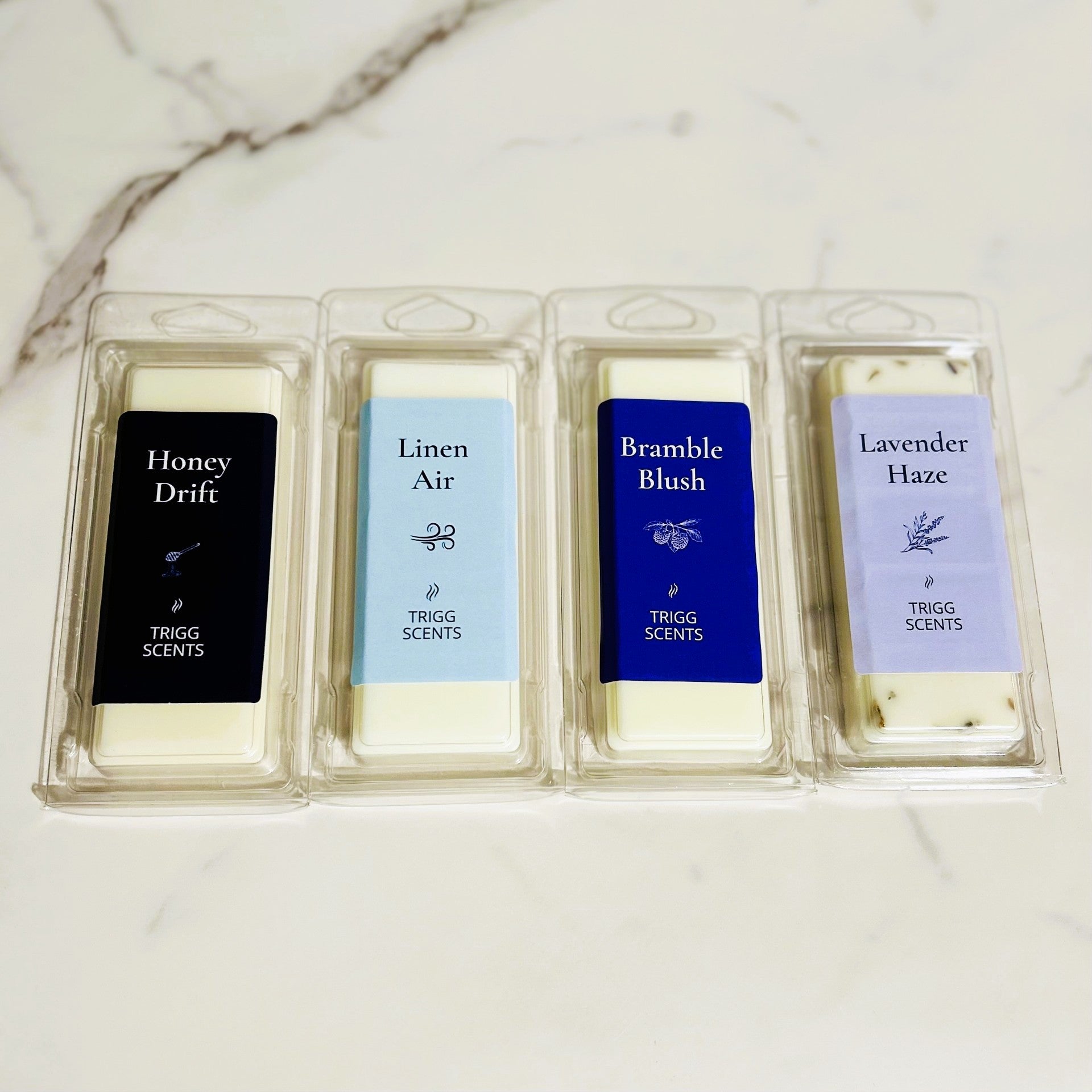 Four scented wax melt bars from the Everyday Melt Set arranged side by side