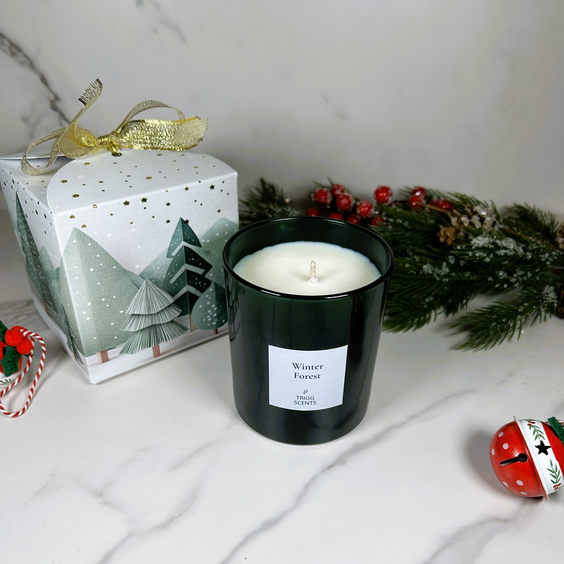 Winter Forest luxury candle by TRIGG SCENTS in green glass jar with festive Christmas gift box.