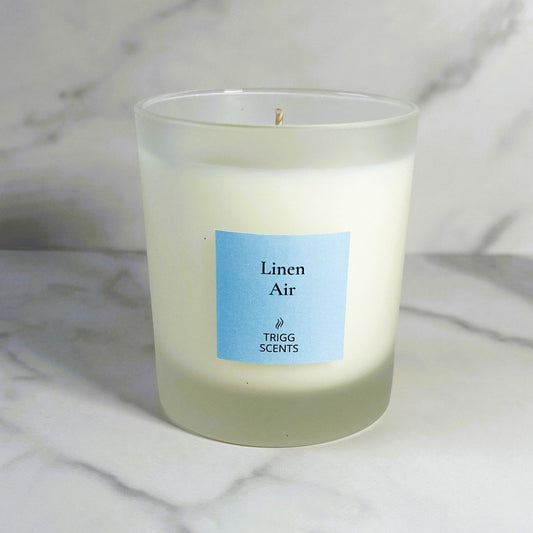 Linen Air fresh linen and clean cotton scented candle on marble background.
