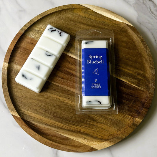 Spring Bluebell wax melts on wooden tray with packaging and snap bar showing decorative botanicals.